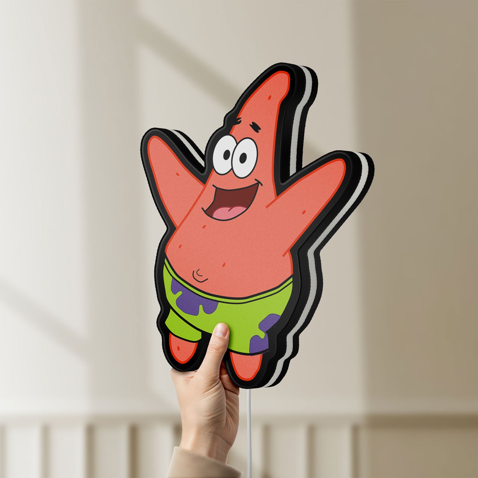 Unlit Patrick Star LED lightbox held by hand to show size and details