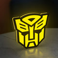 Autobots LED lightbox standing on a desk from an angled side view with yellow glow