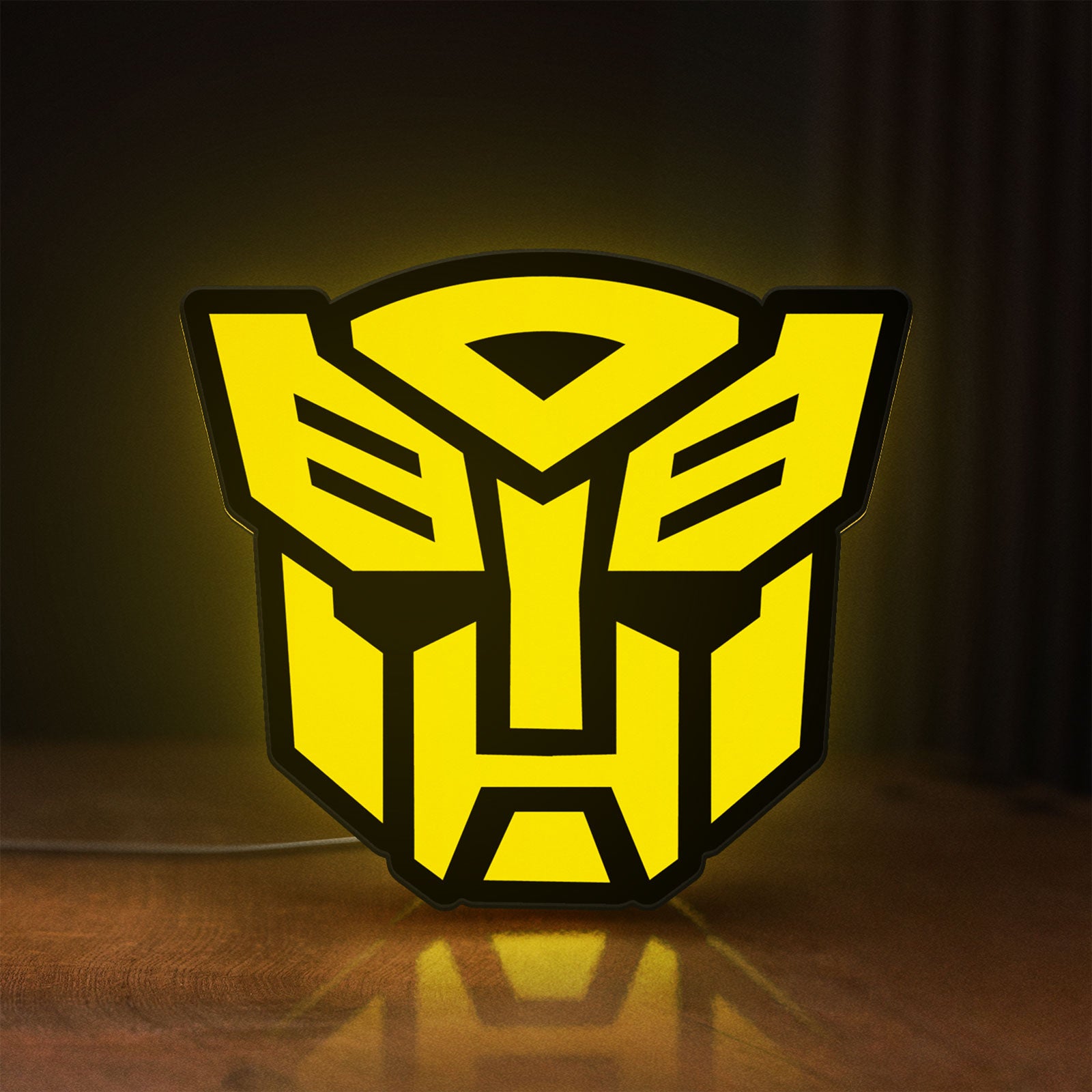 Front view of Autobots LED lightbox sign glowing on a wooden desk