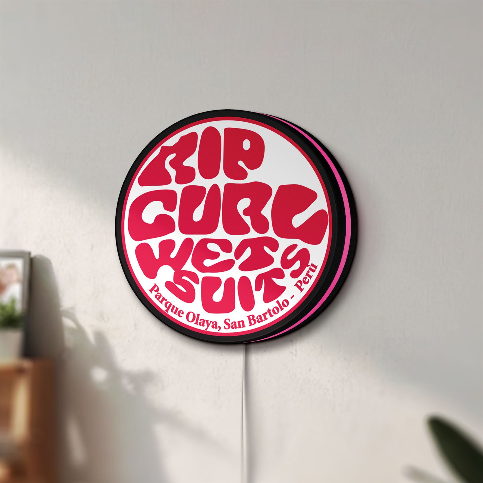 Unlit Rip Curl LED lightbox mounted on a wall in daylight