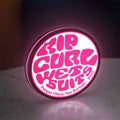 Rip Curl LED lightbox standing on a desk from an angled side view with pink glow