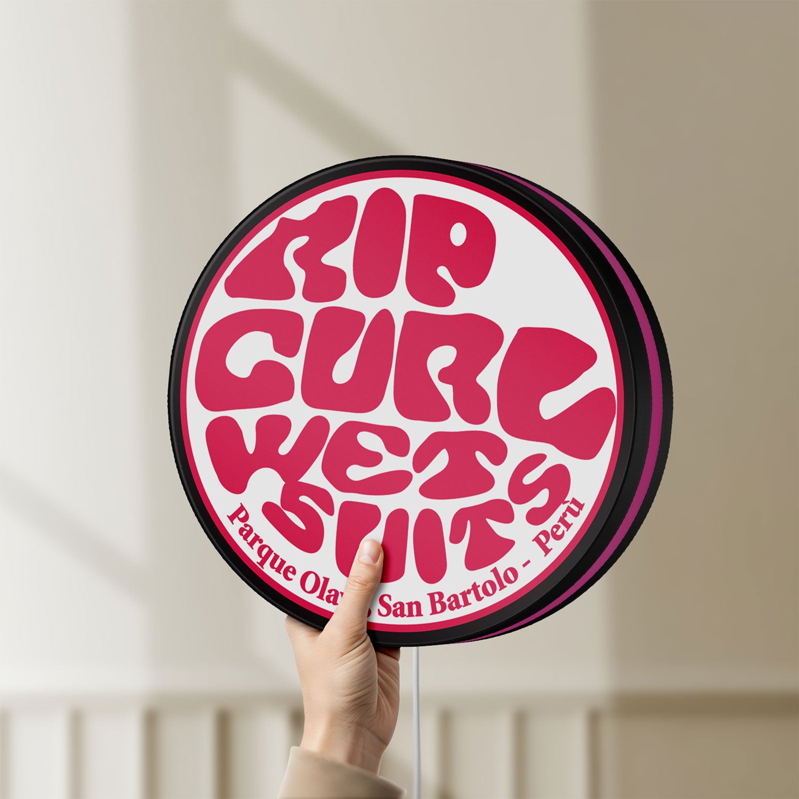 Unlit Rip Curl LED lightbox held by hand to show size and details