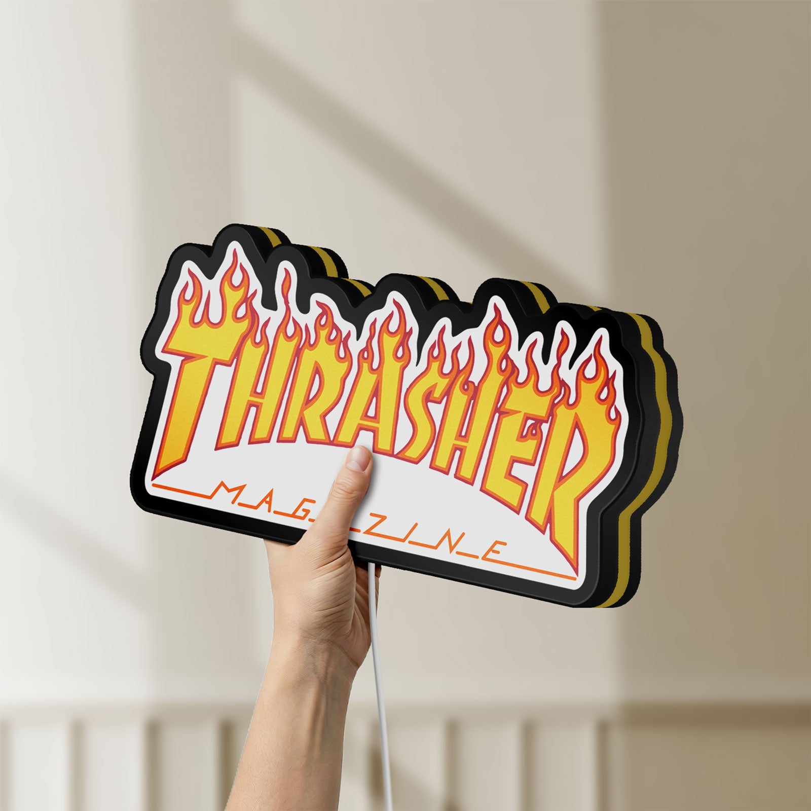 Unlit Thrasher Magazine LED lightbox held by hand to show size and details