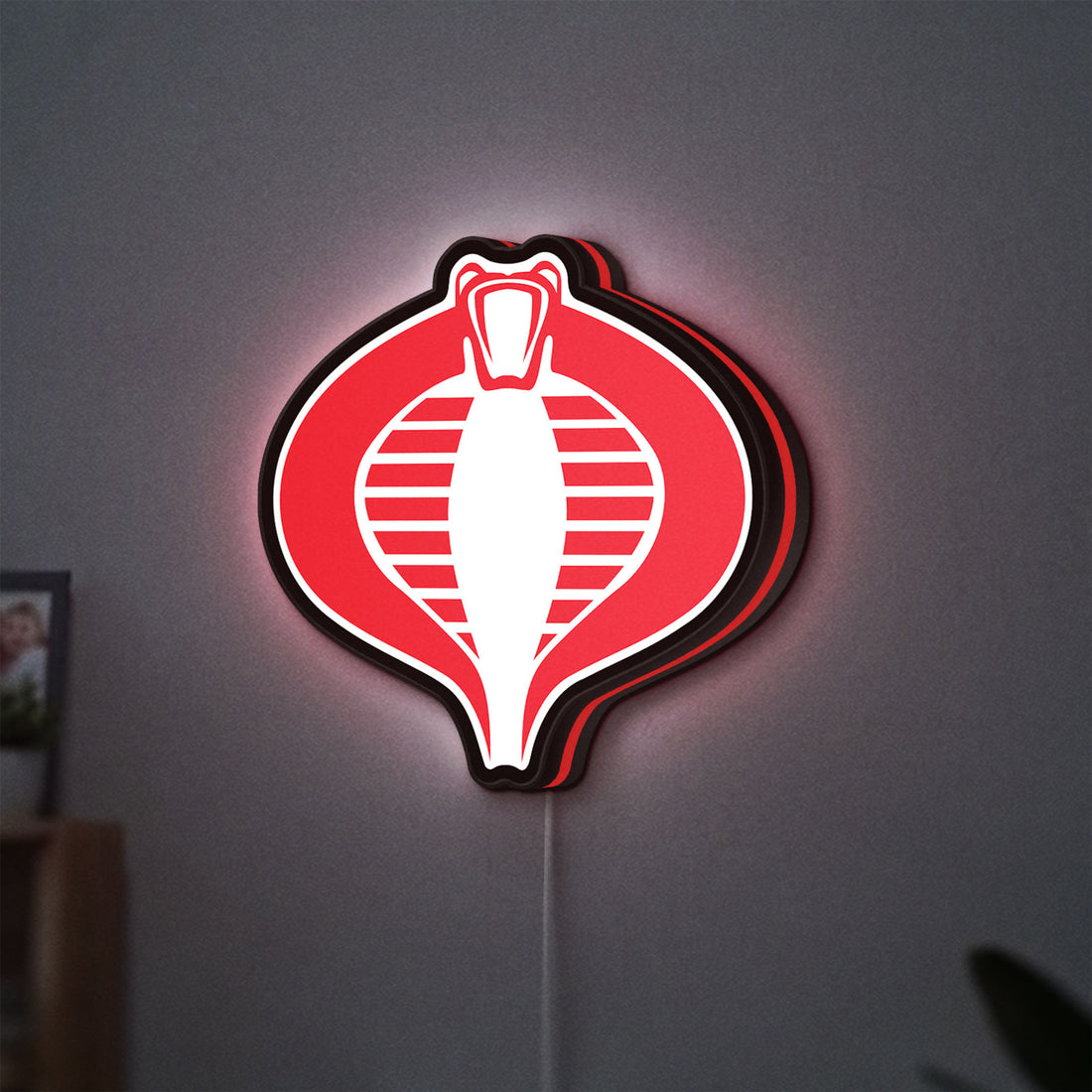G.I. Joe Cobra LED lightbox hanging on a wall with red glow