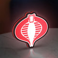 G.I. Joe Cobra LED lightbox standing on a desk from an angled side view with red glow