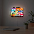 Disney's Cars Characters LED lightbox hanging on a room wall with soft white light
