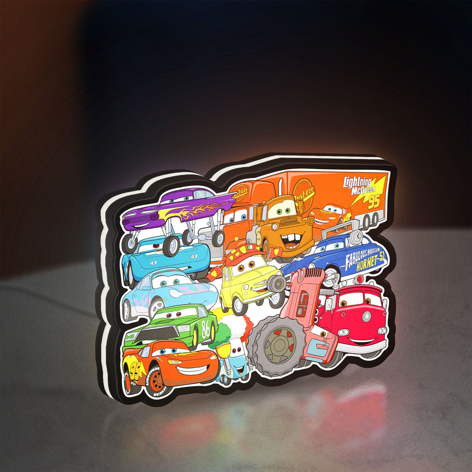 Disney's Cars Characters LED lightbox standing on a desk from an angled side view with white glow