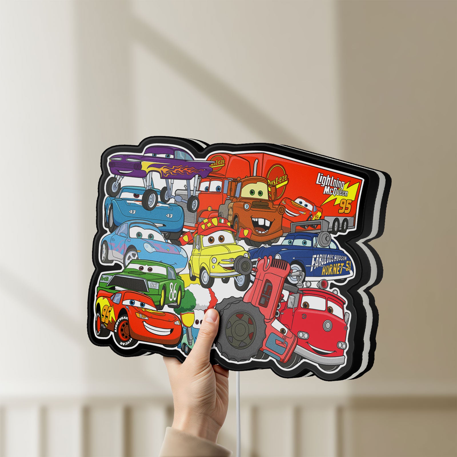 Unlit Disney's Cars Characters LED lightbox held by hand to show size and details