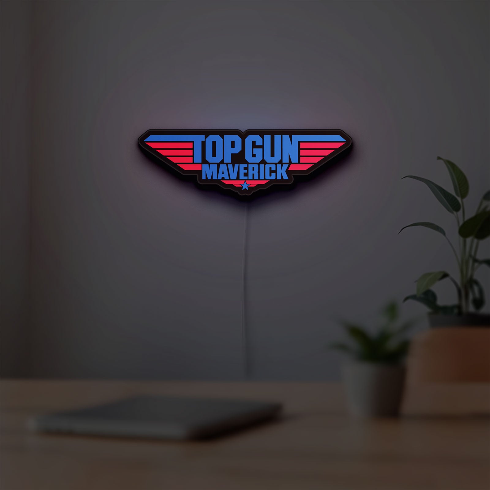 Top Gun Maverick LED lightbox hanging on a room wall with soft blue light