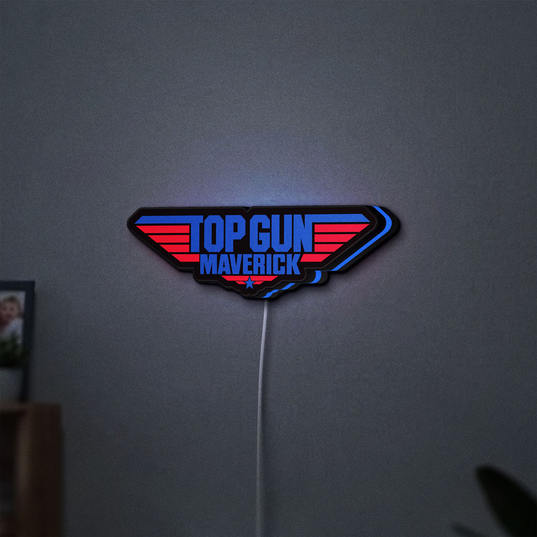 Top Gun Maverick LED lightbox hanging on a wall with blue glow