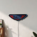Unlit Top Gun Maverick LED lightbox mounted on a wall in daylight