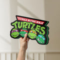 Unlit Teenage Mutant Ninja Turtles LED lightbox held by hand to show size and details