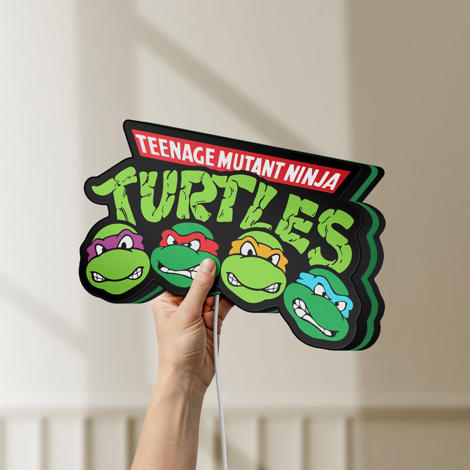 Unlit Teenage Mutant Ninja Turtles LED lightbox held by hand to show size and details