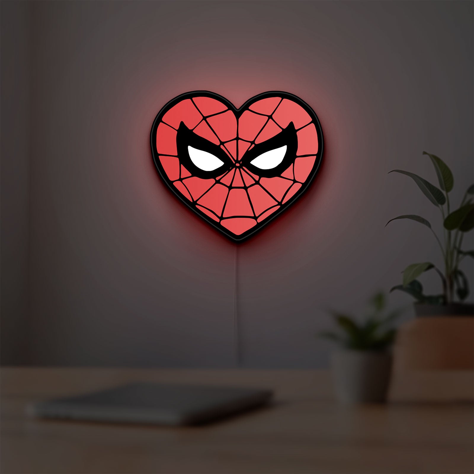 Spiderman Heart LED lightbox hanging on a room wall with soft red light