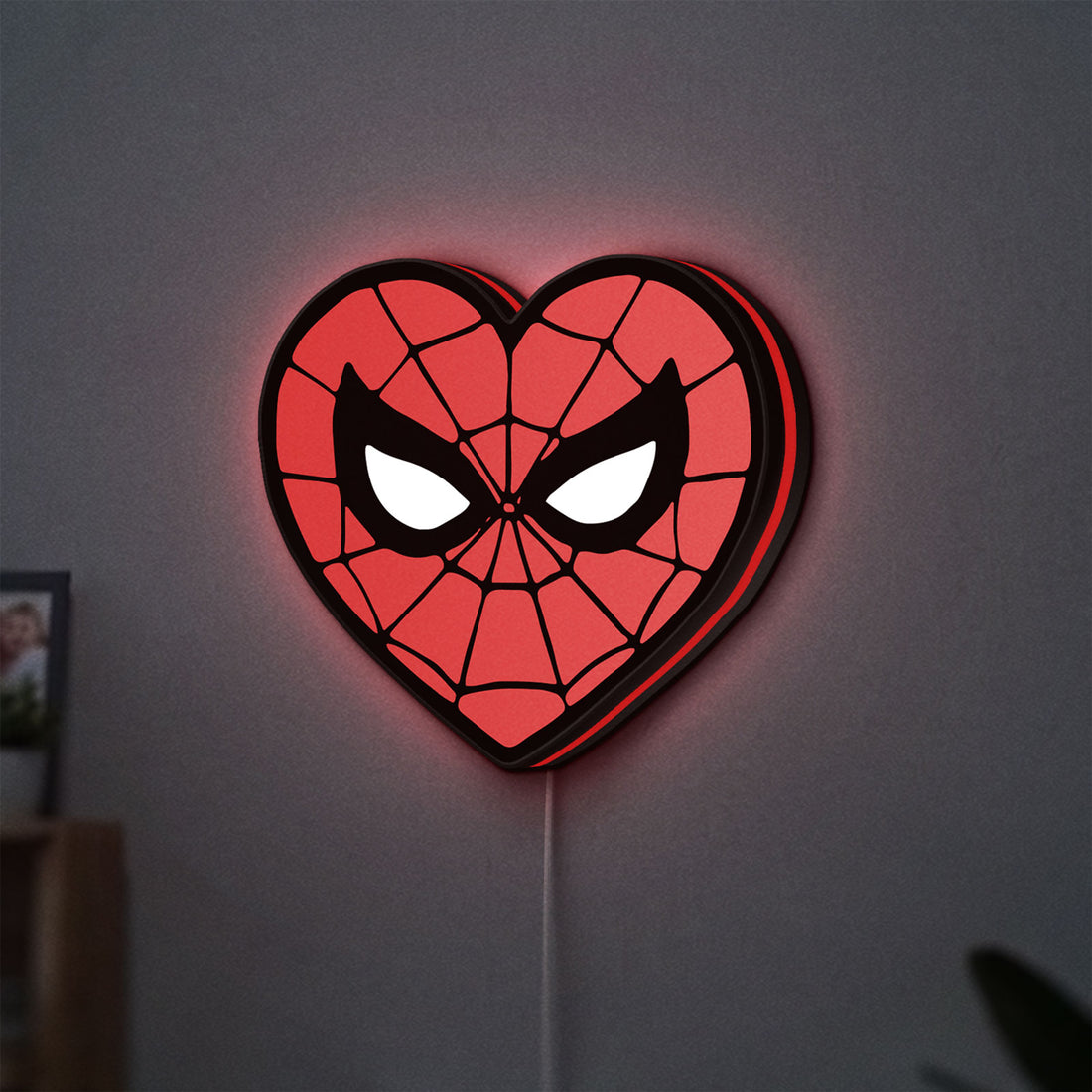 Spiderman Heart LED lightbox hanging on a wall with red glow