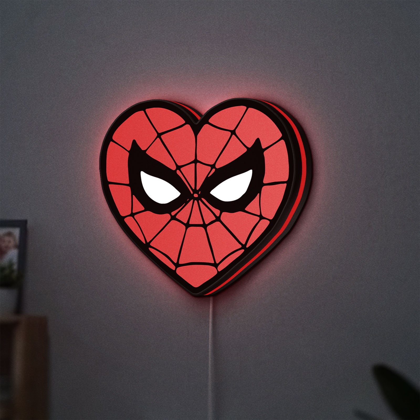 Spiderman Heart LED lightbox hanging on a wall with red glow