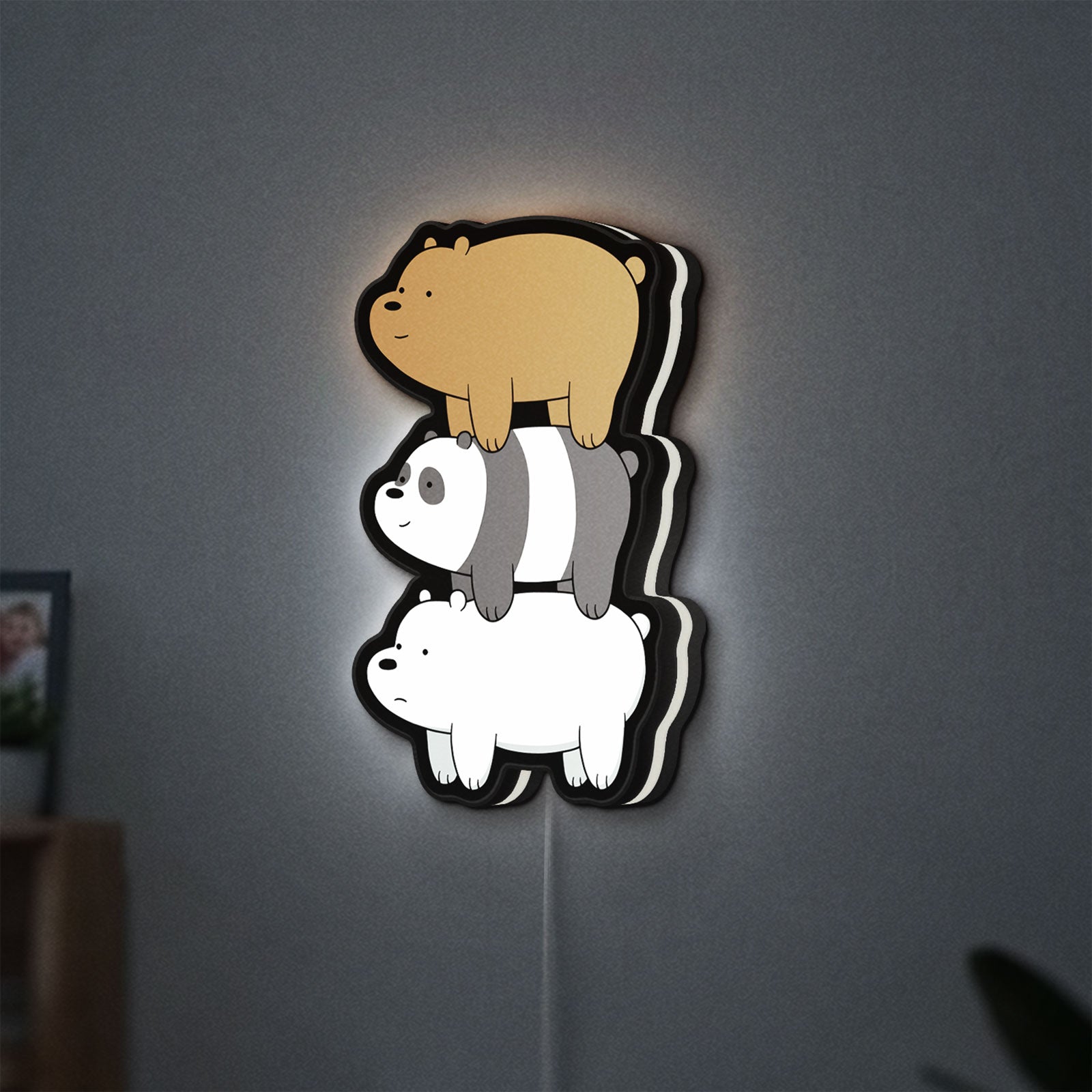 We Bare Bears Stacked Bears LED lightbox hanging on a wall with white glow