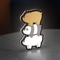 We Bare Bears Stacked Bears LED lightbox standing on a desk from an angled side view with white glow