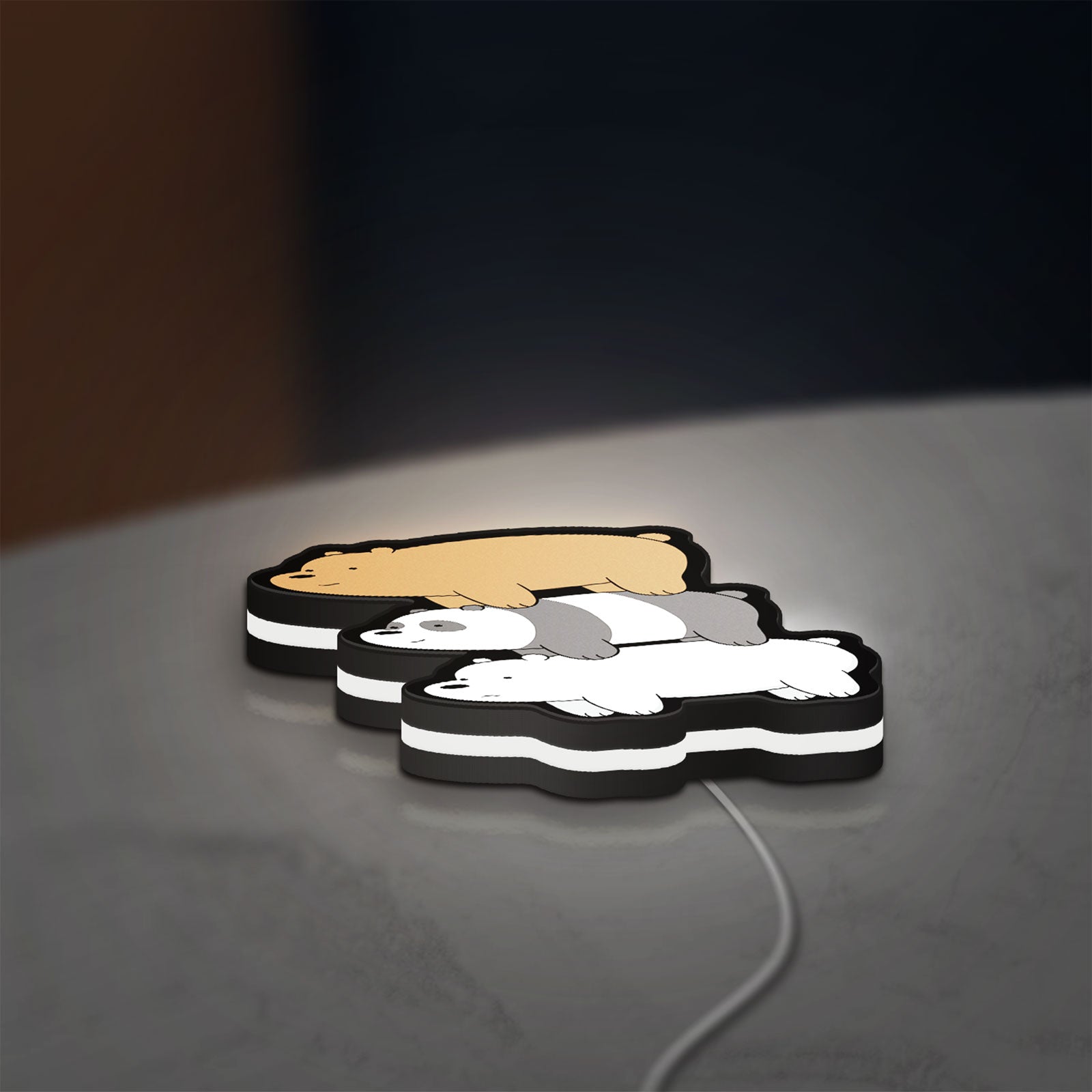 We Bare Bears Stacked Bears LED lightbox lying flat on a desk with white glow