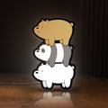 Front view of We Bare Bears Stacked Bears LED lightbox sign glowing on a wooden desk