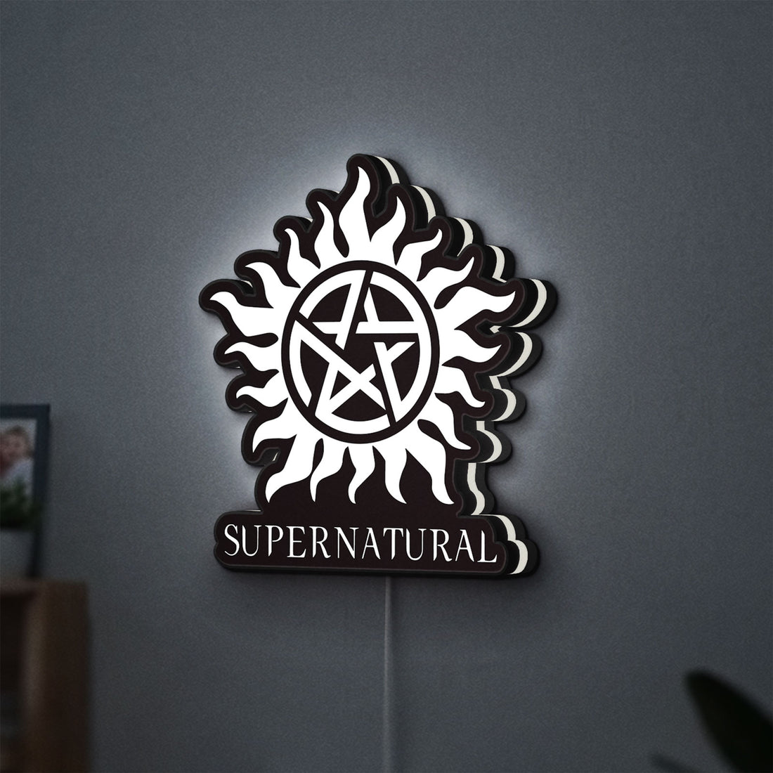 Supernatural LED lightbox hanging on a wall with white glow
