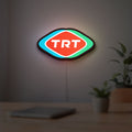 TRT LED lightbox hanging on a room wall with soft white light