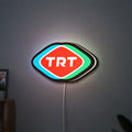 TRT LED lightbox hanging on a wall with white glow
