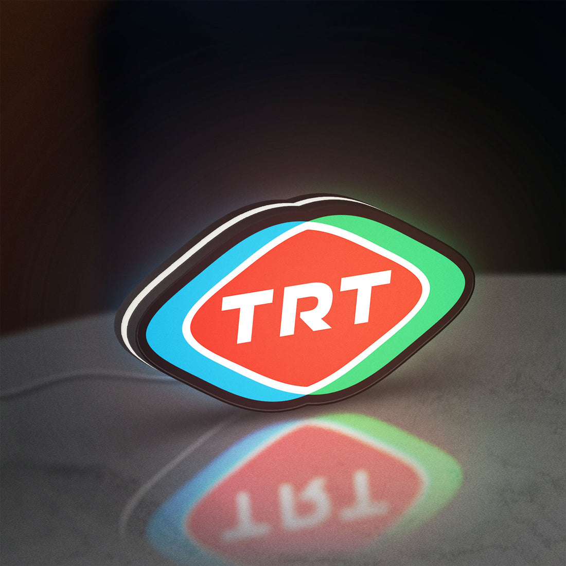 TRT LED lightbox hanging on a wall with white glow