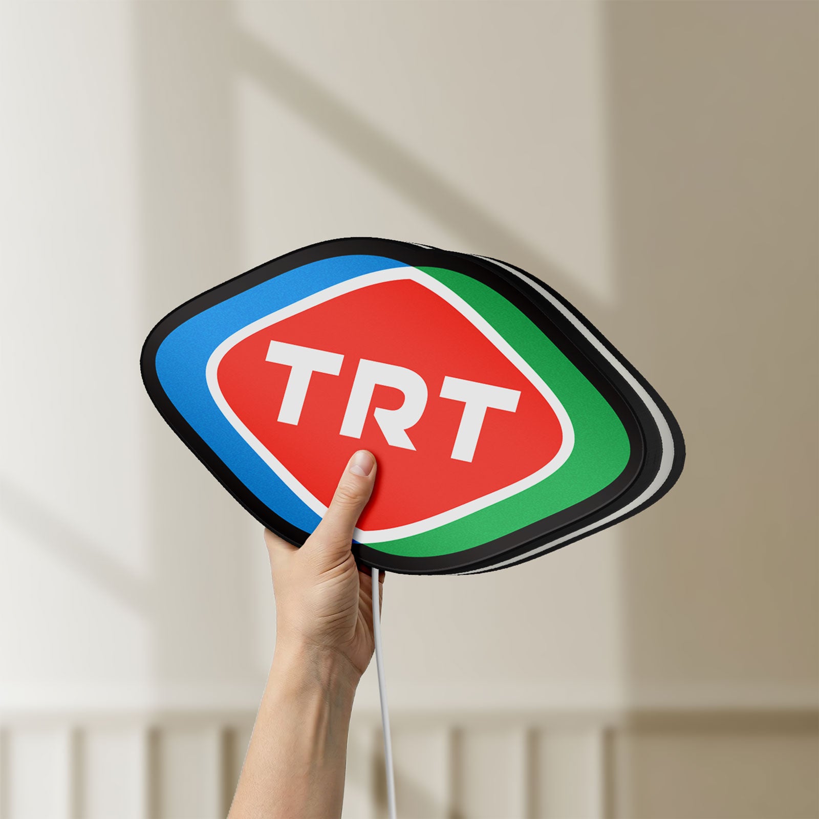 Unlit TRT LED lightbox held by hand to show size and details