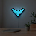 Nightwing LED lightbox hanging on a room wall with soft blue light