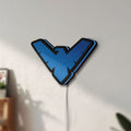 Unlit Nightwing LED lightbox mounted on a wall in daylight