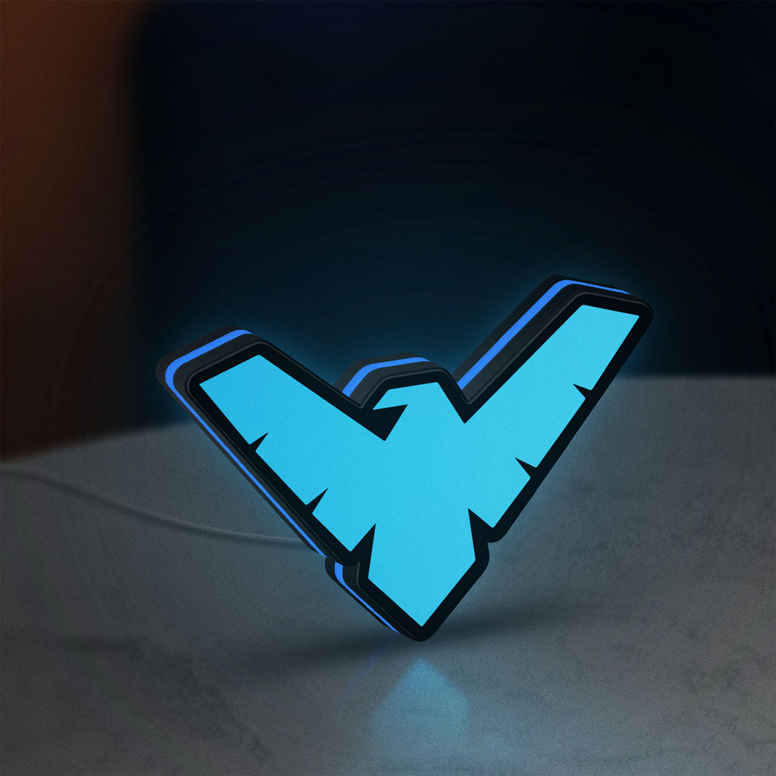 Nightwing LED lightbox hanging on a wall with blue glow