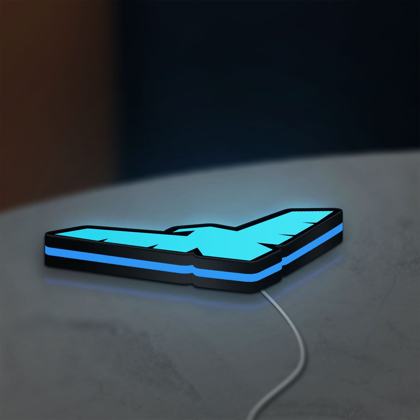 Nightwing LED lightbox lying flat on a desk with blue glow