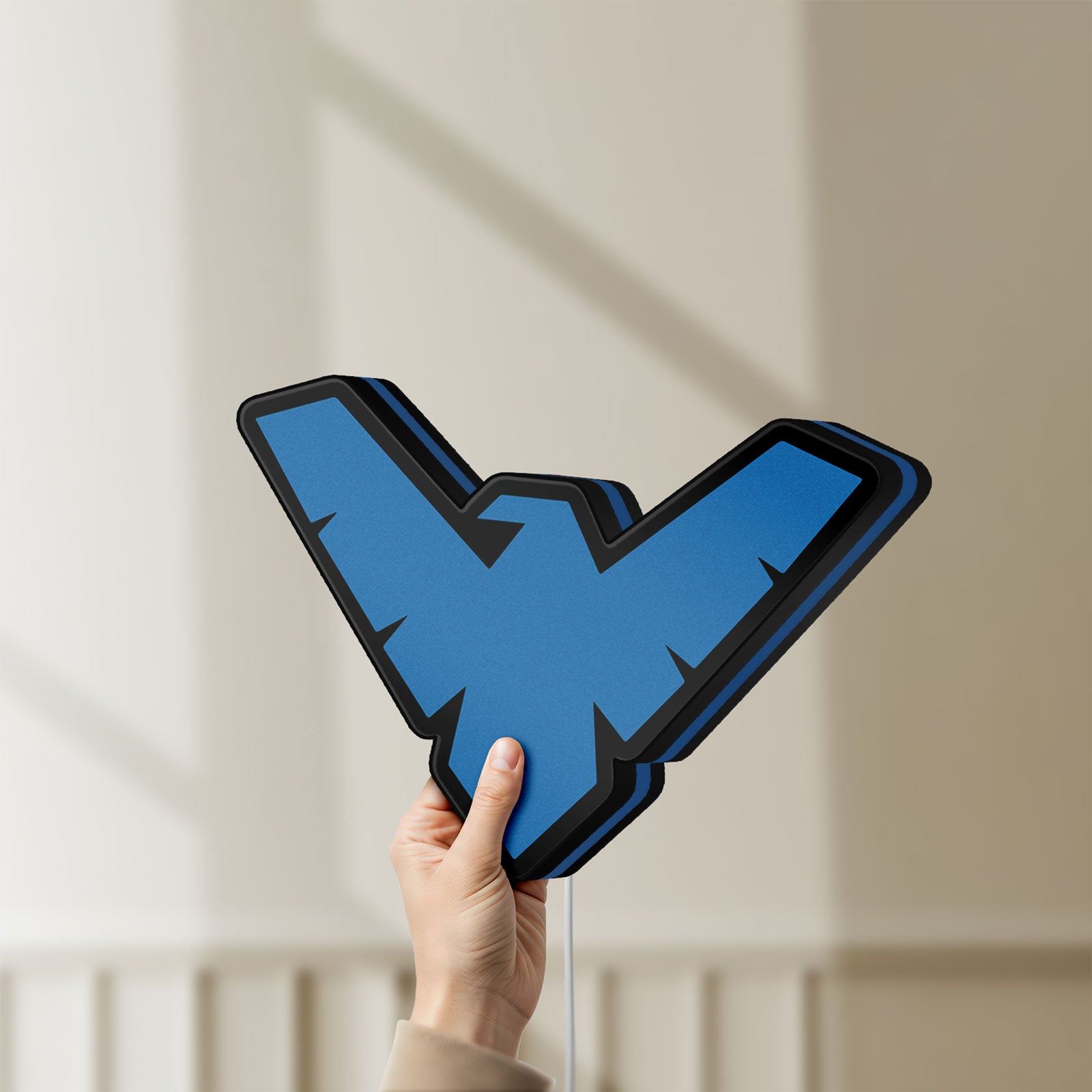 Unlit Nightwing LED lightbox held by hand to show size and details