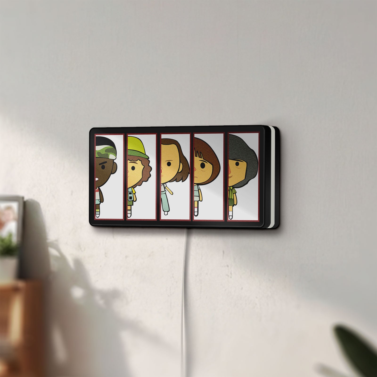 Unlit Stranger Things LED lightbox mounted on a wall in daylight