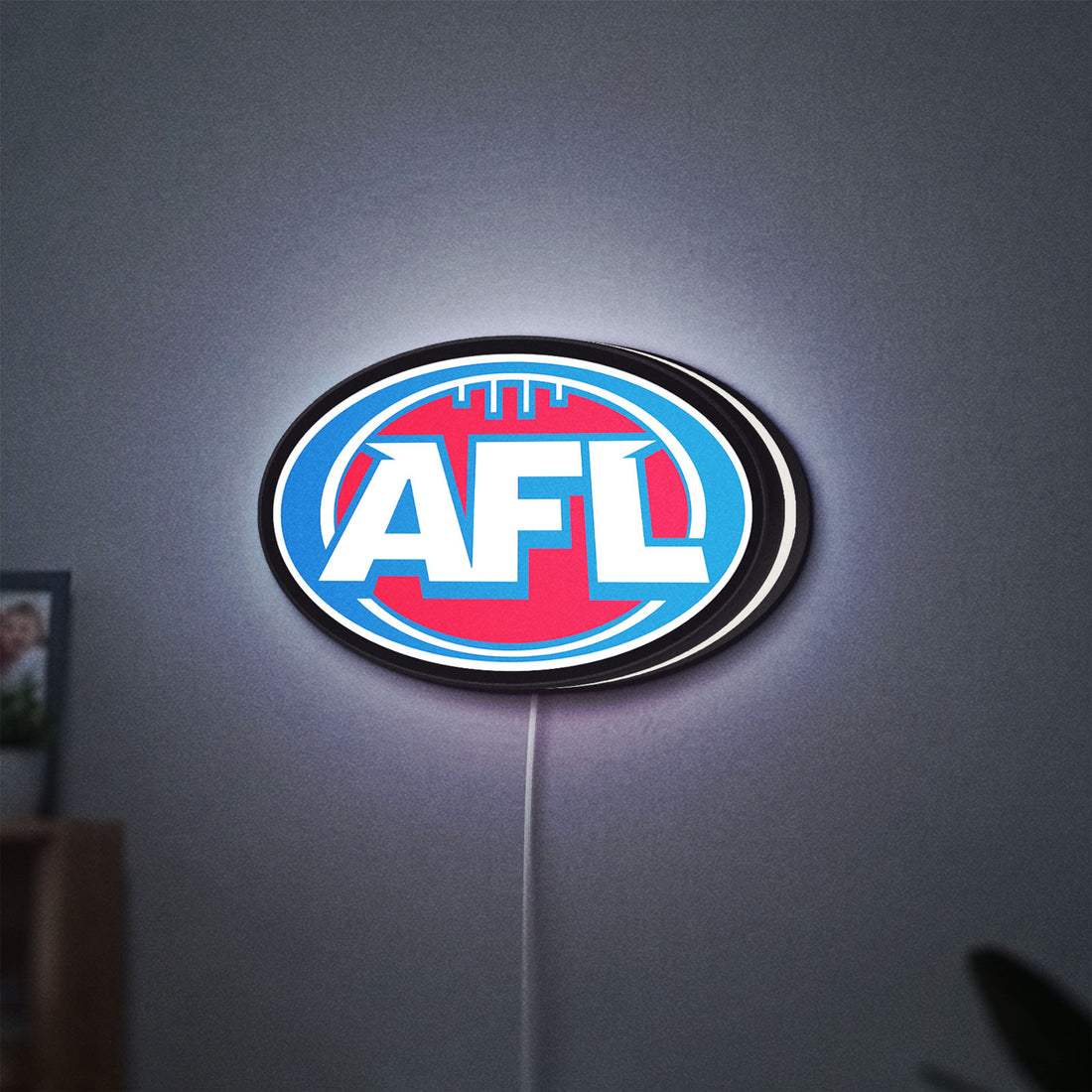 AFL LED lightbox hanging on a wall with white glow