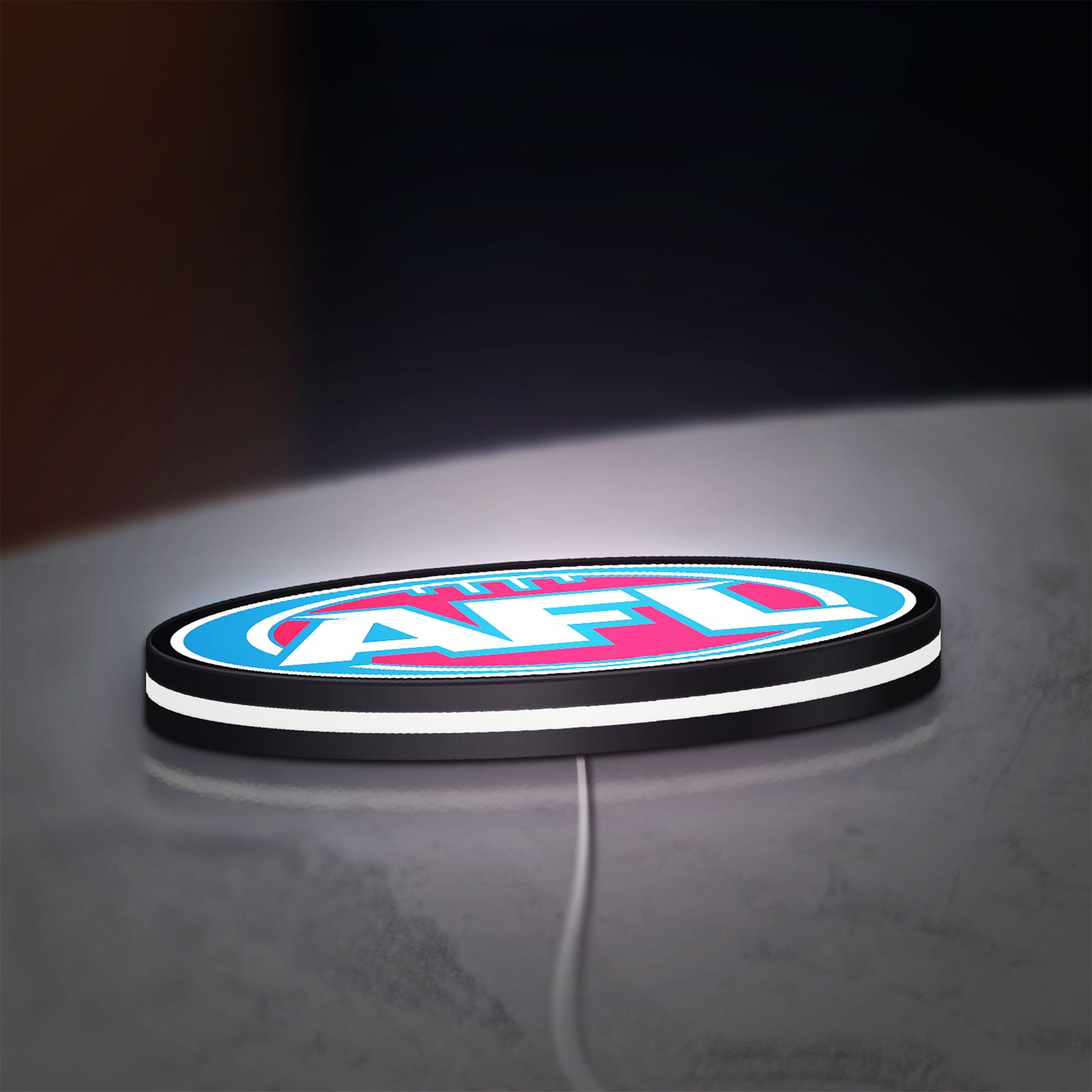 AFL LED lightbox lying flat on a desk with white glow