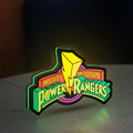 Mighty Morphin Power Rangers LED lightbox standing on a desk from an angled side view with green glow
