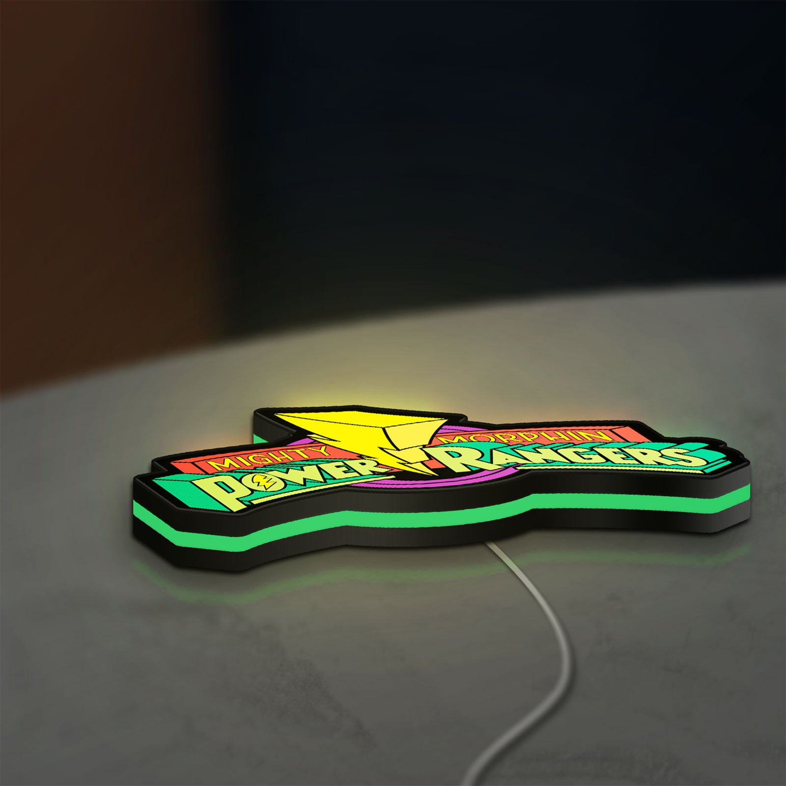 Mighty Morphin Power Rangers LED lightbox lying flat on a desk with green glow