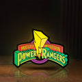 Front view of Mighty Morphin Power Rangers LED lightbox sign glowing on a wooden desk