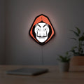 La Casa De Papel LED lightbox hanging on a room wall with soft red light