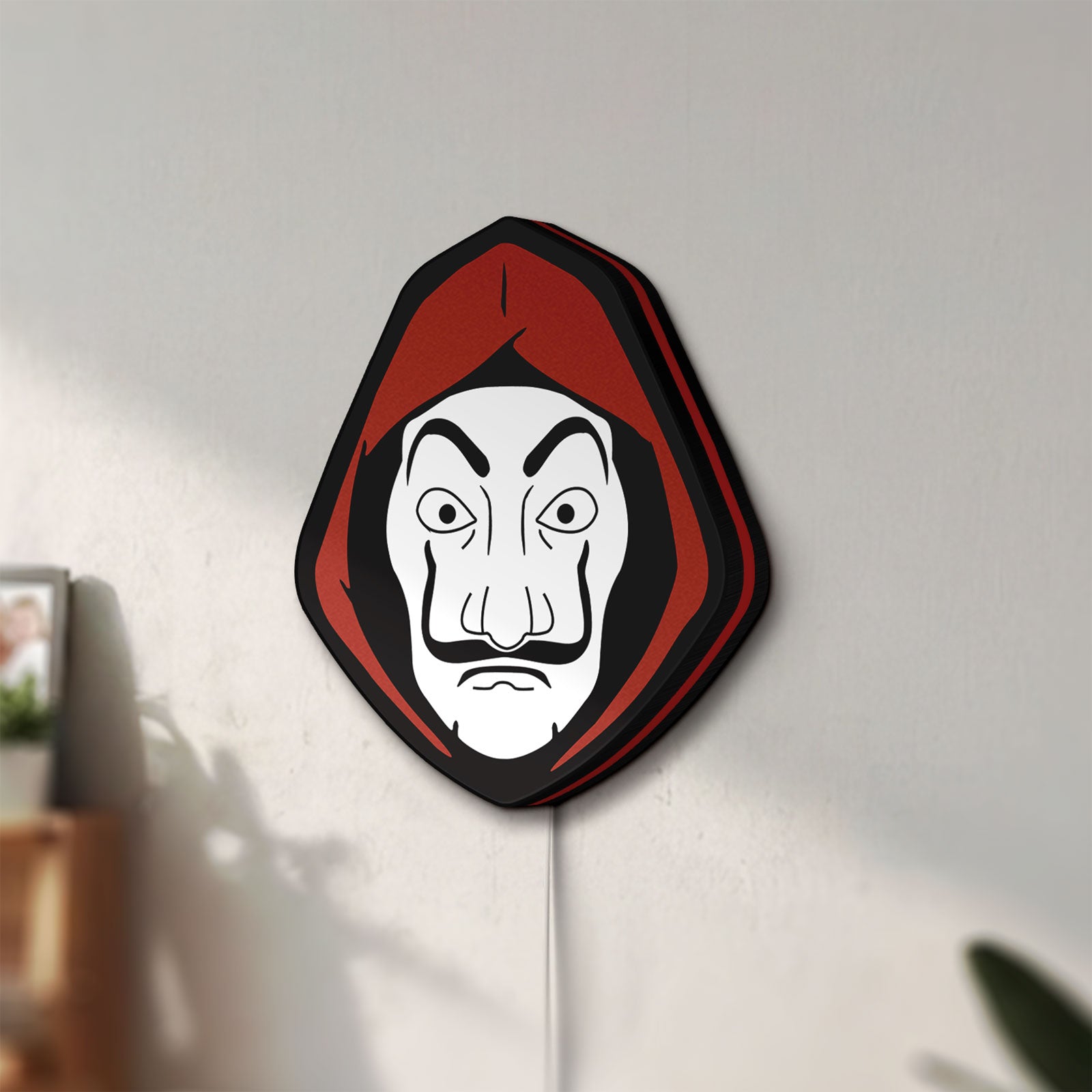 Unlit La Casa De Papel LED lightbox mounted on a wall in daylight