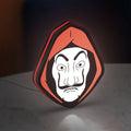 La Casa De Papel LED lightbox standing on a desk from an angled side view with red glow