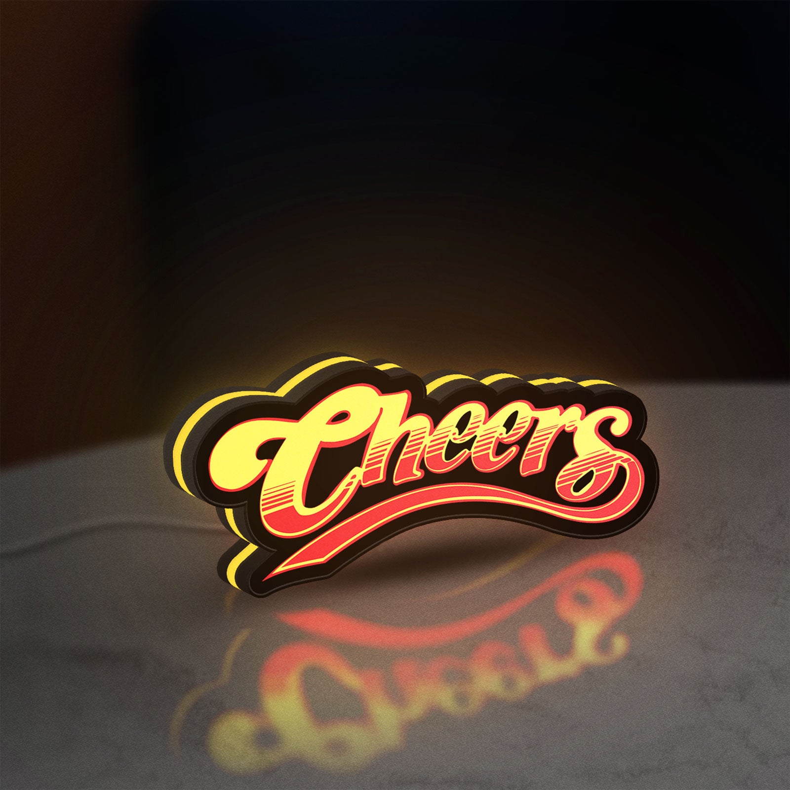 Cheers LED lightbox standing on a desk from an angled side view with yellow glow