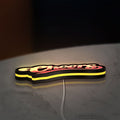 Cheers LED lightbox lying flat on a desk with yellow glow