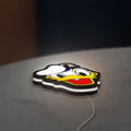 Donald LED lightbox lying flat on a desk with white glow