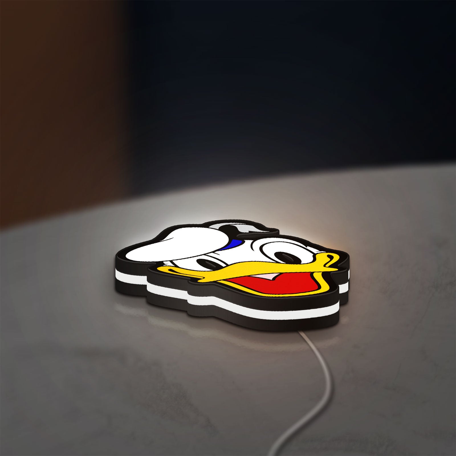 Donald LED lightbox lying flat on a desk with white glow