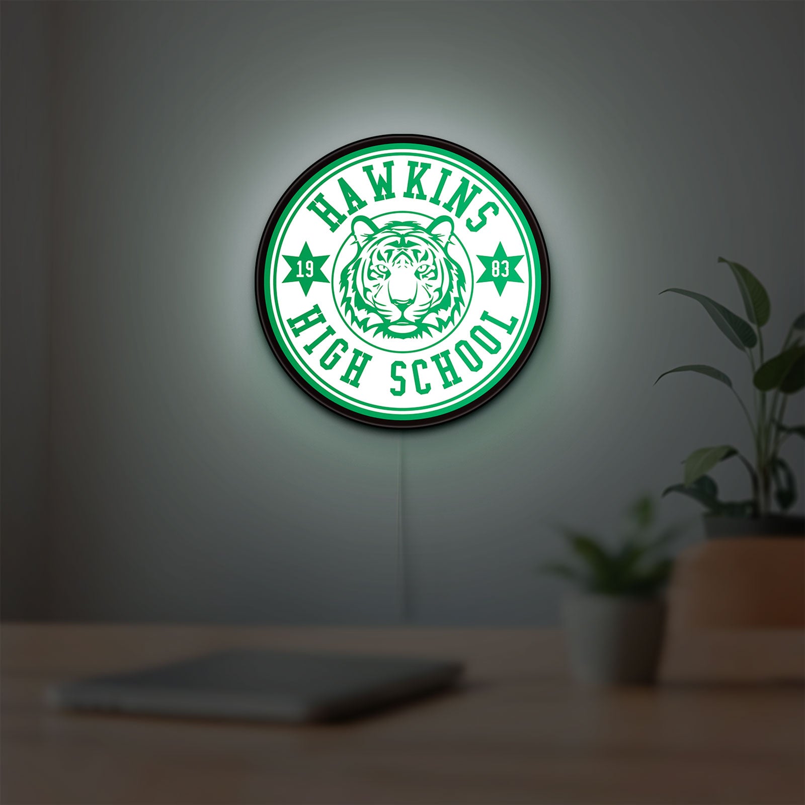 Hawkins Stranger Things LED lightbox hanging on a room wall with soft green light