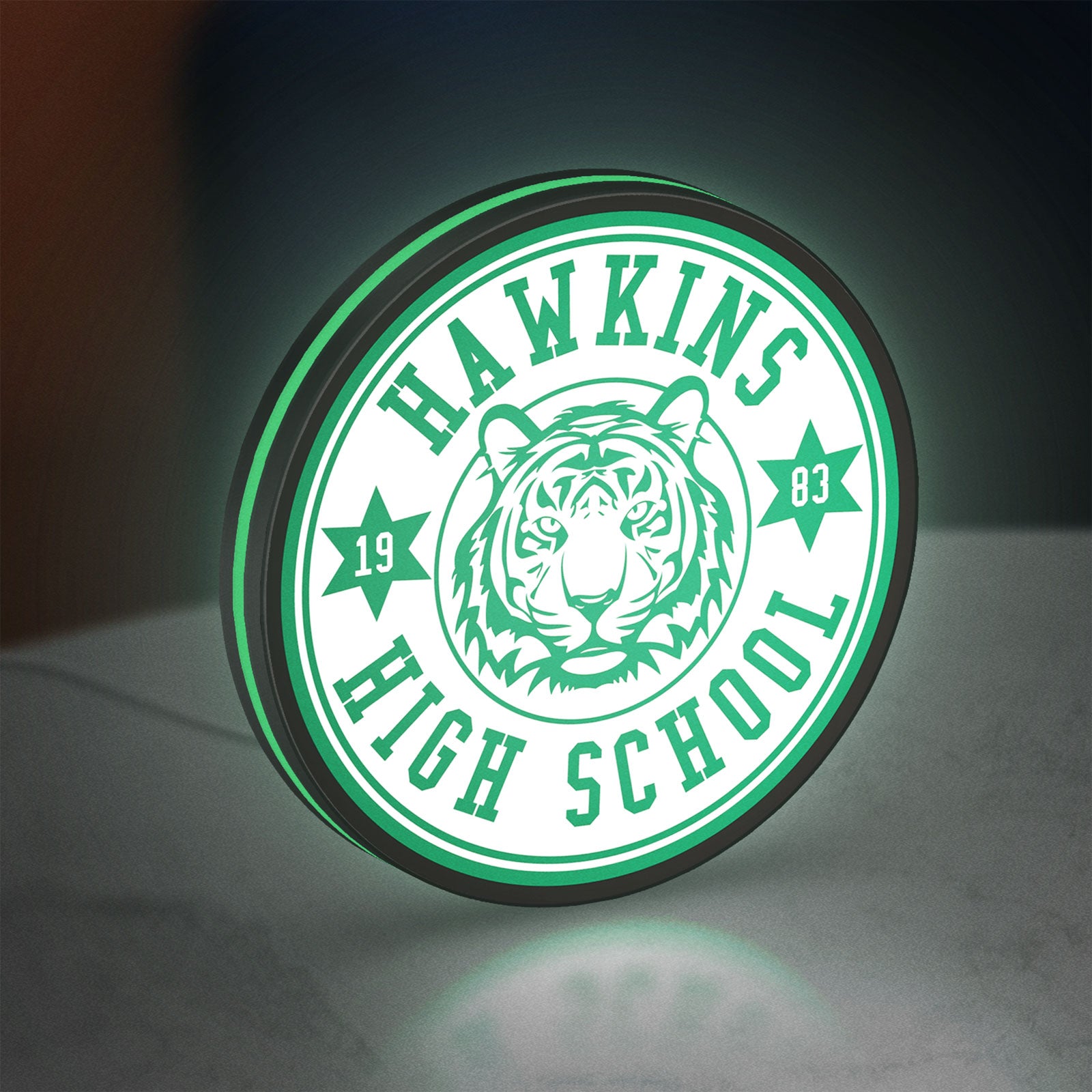 Hawkins Stranger Things LED lightbox standing on a desk from an angled side view with green glow