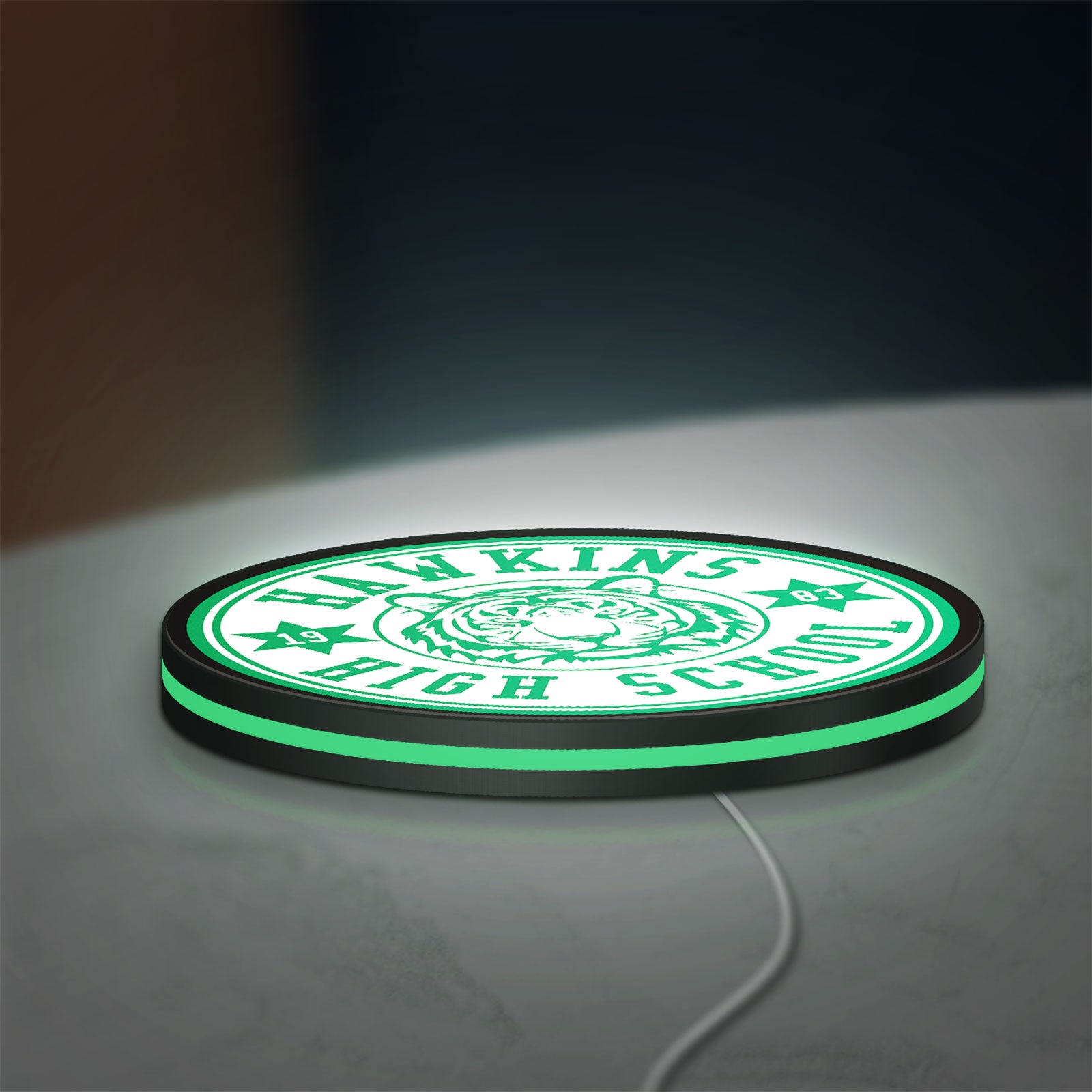 Hawkins Stranger Things LED lightbox lying flat on a desk with green glow